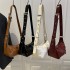 Wholesale Korean-style simple hand-held pillow bags, women's bags, 2025 summer new high-end quality single-shoulder bags, and commuting crossbody bags